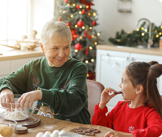 A grandmother and granddaughter baking together